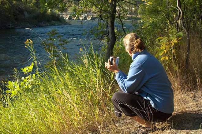 Sue Kronen having morning coffee while watching the river flow
